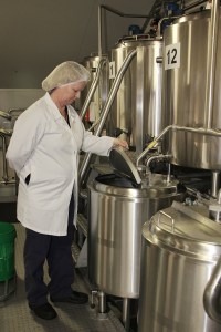 NORCO icecream factory worker checks an icecream vat